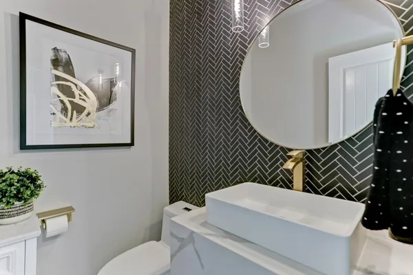 a bathroom with a toilet a sink and a mirror