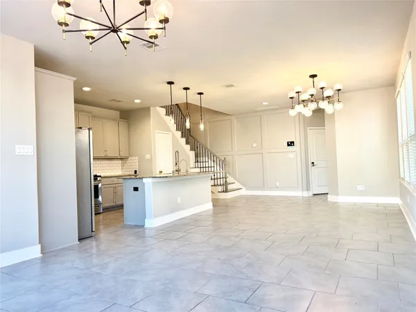 a view of a kitchen with a refrigerator and a sink