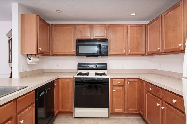 a kitchen with sink cabinets and stainless steel appliances