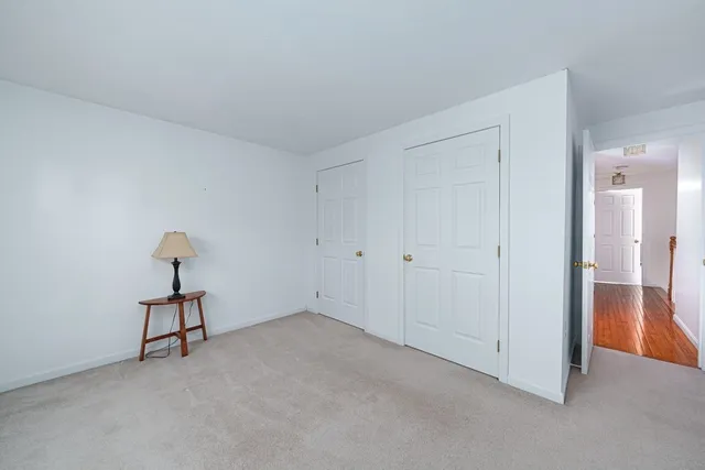 a view of an empty room and closet area