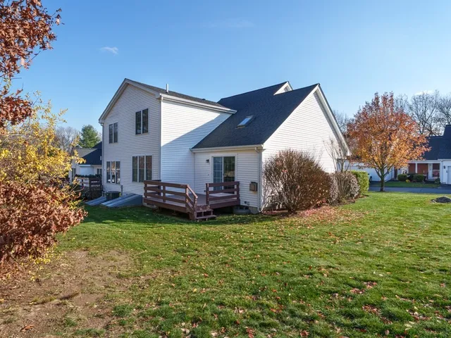 a view of a house with a yard and sitting area