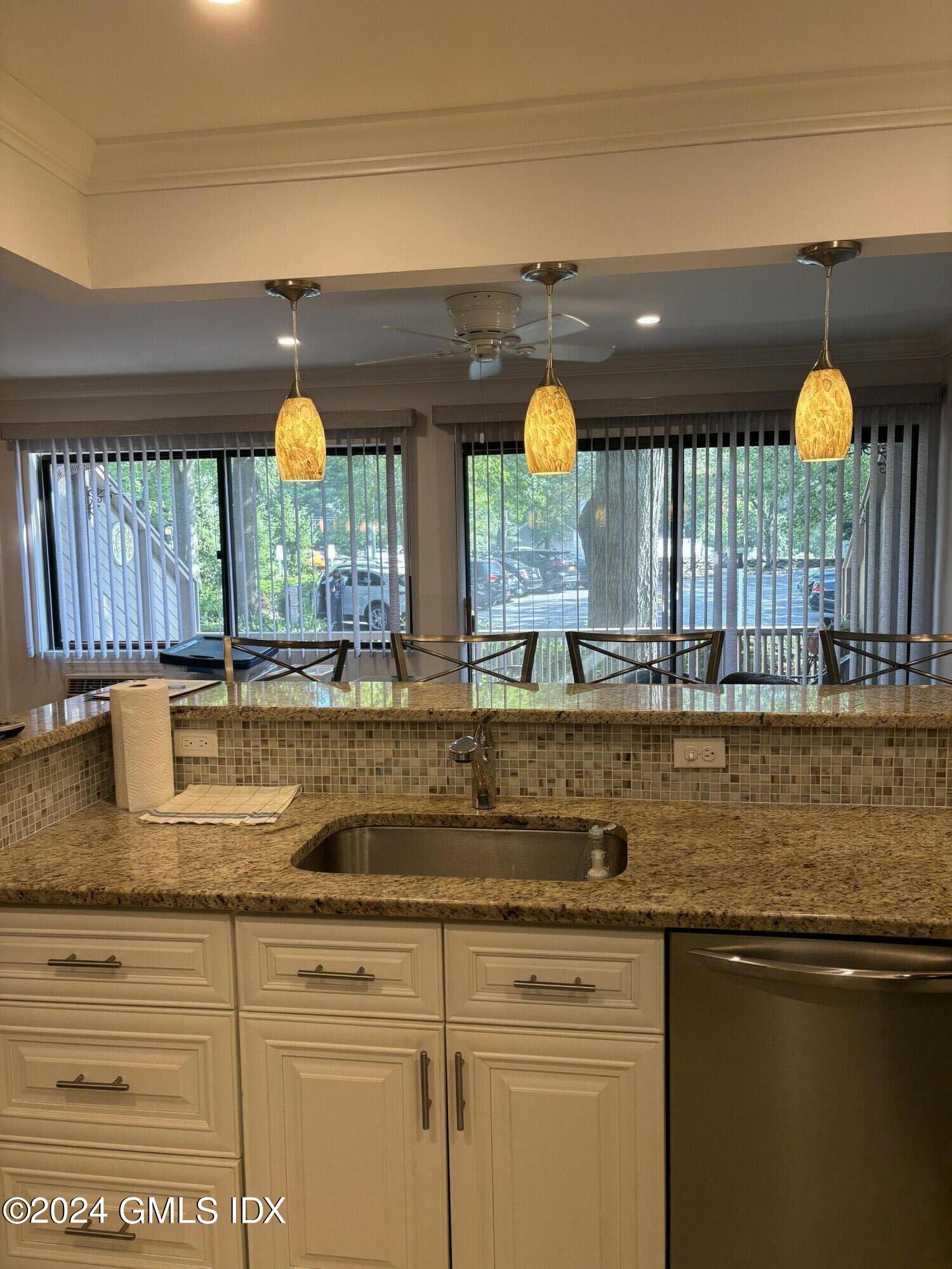 1465 East Putnam Avenue, Unit 306 Riverside, CT 06878 - Photo 5 of 13 a kitchen with a sink and a window