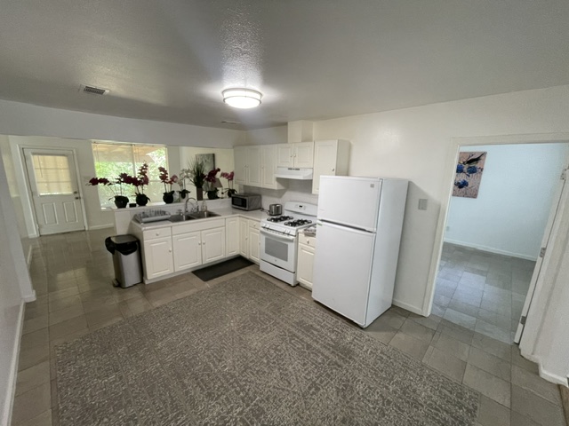 4611 Glissman Road Austin, TX 78702 - Photo 3 of 11 A compact kitchen offers essential amenities for everyday living.
