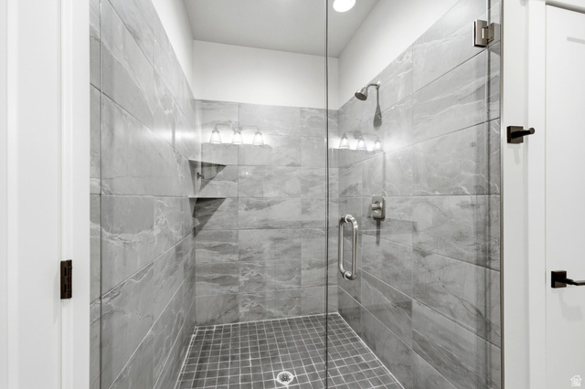 496 North Farmhouse Way, Unit 11 Midway, UT 84049 - Photo 36 of 50 Glass-enclosed shower featuring large format gray tile walls and a mosaic tile floor