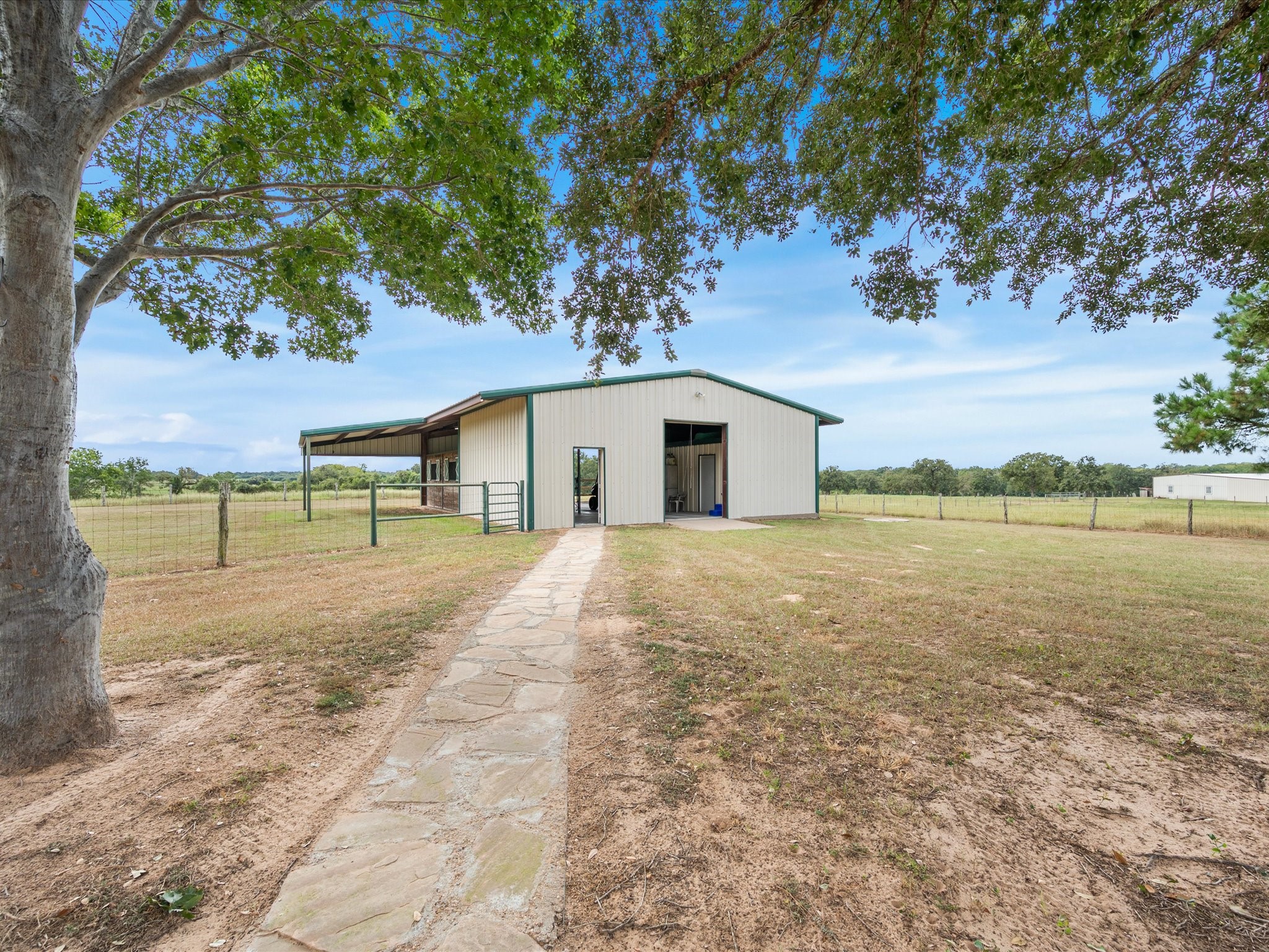 19929 Pierceall Road Hempstead, TX 77445 - Photo 32 of 50 The well-appointed barn features stables, dedicated storage rooms, and ample space to support your equestrian needs and country lifestyle.