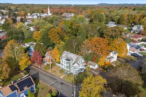 an aerial view of residential houses with outdoor space
