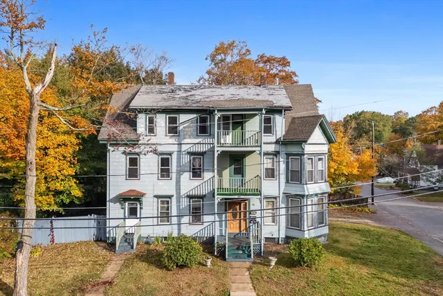 a front view of a residential apartment building with a yard