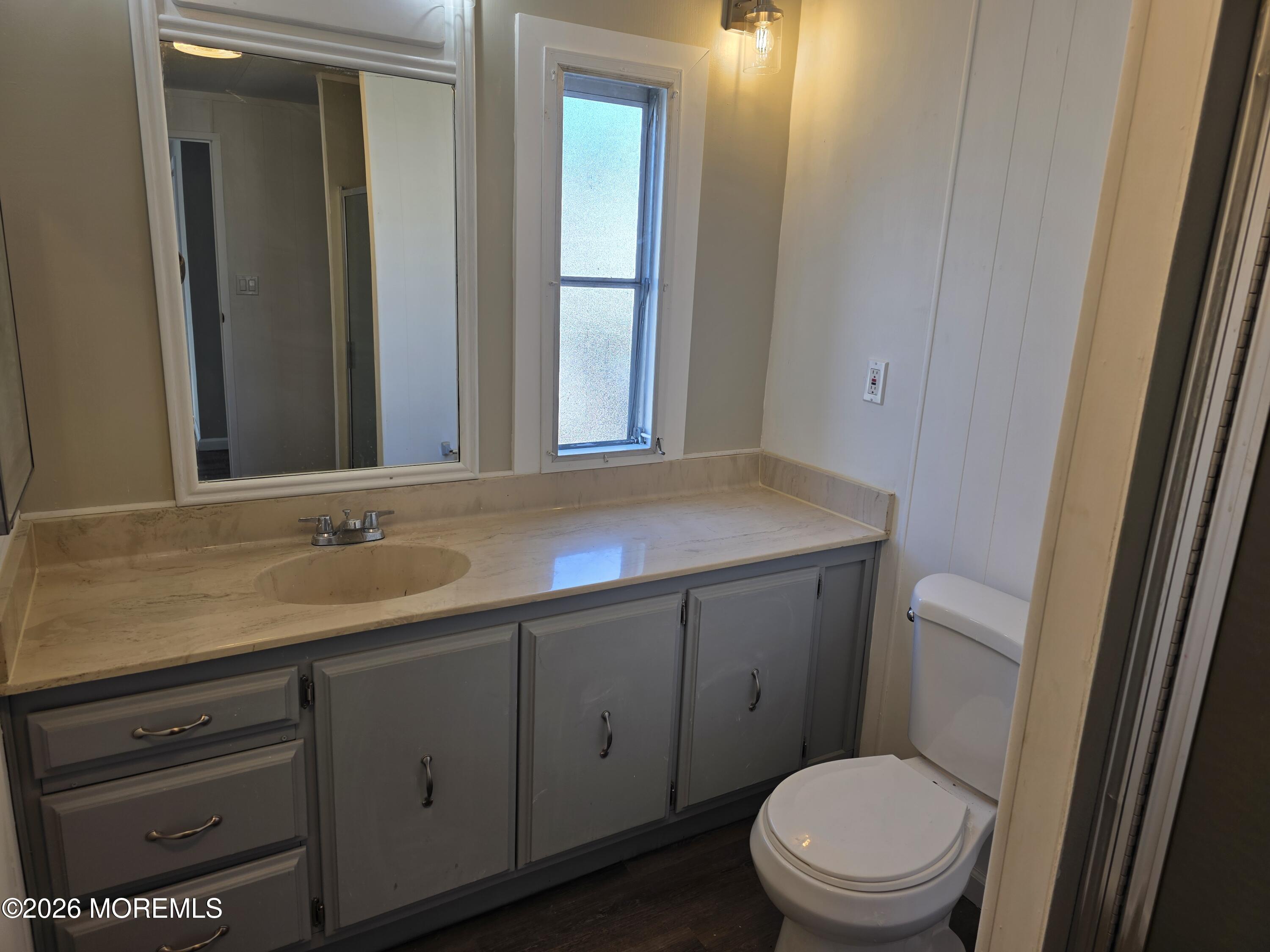 469 South Green Street, Unit 26 Tuckerton, NJ 08087 - Photo 13 of 17 a bathroom with a toilet a sink a vanity and mirror