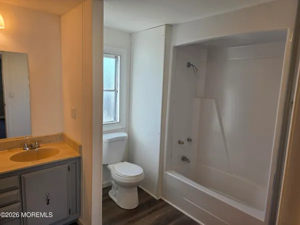 a bathroom with a sink a mirror and a shower
