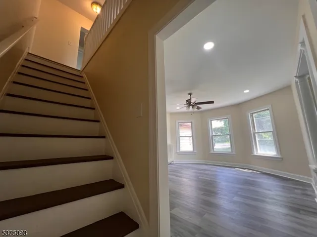 a view of entryway and hall with wooden floor