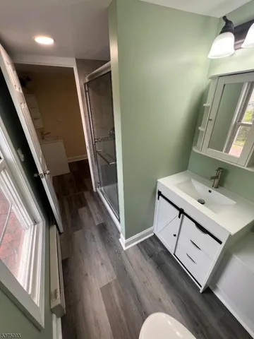 a bathroom with a sink mirror and vanity