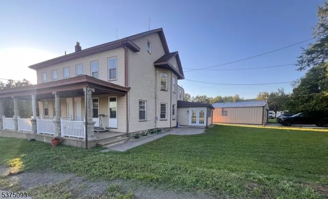 a view of a house with a yard and deck