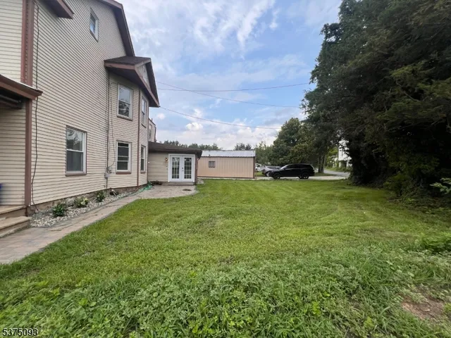 a view of a house with a backyard