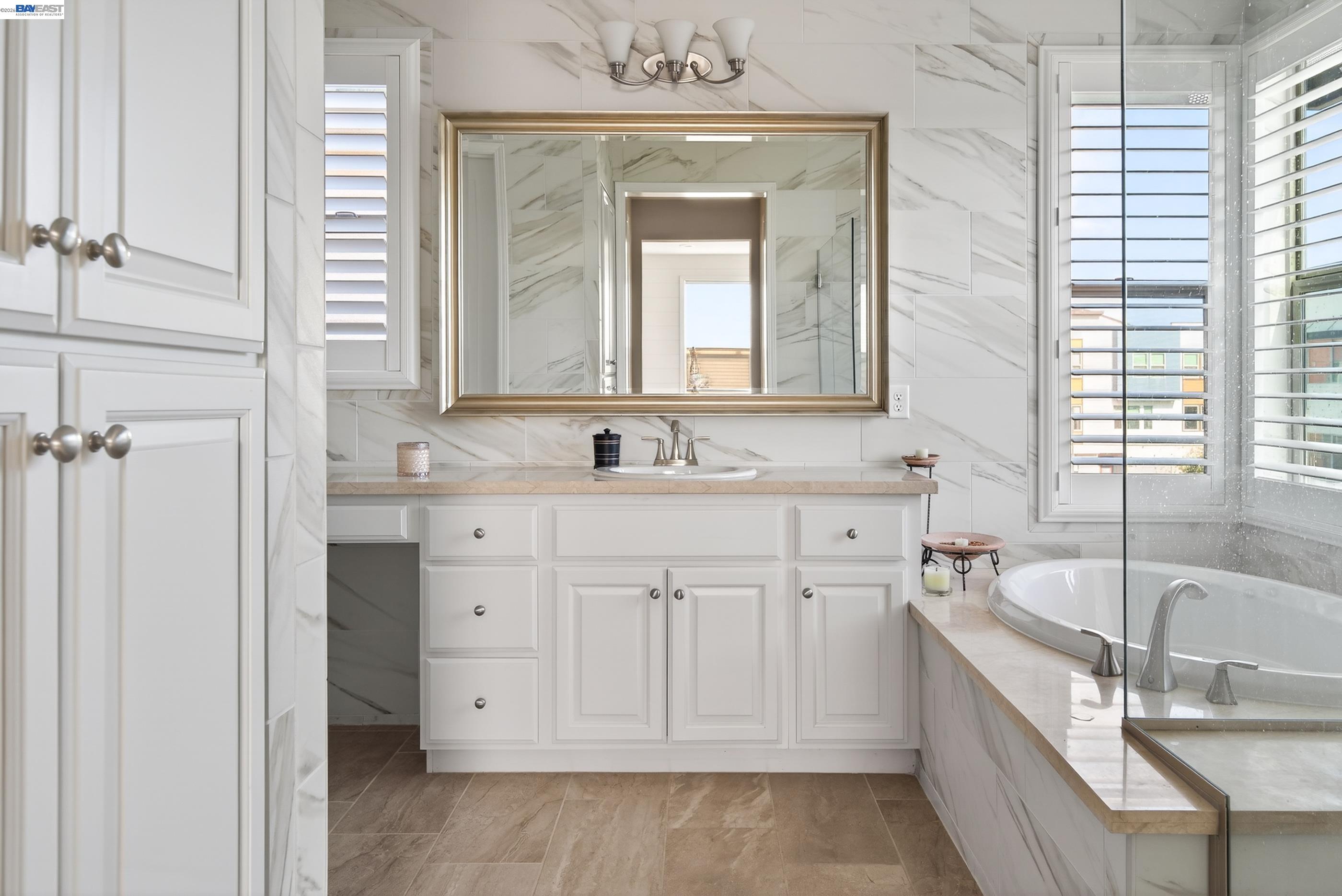 5531 Metropolitan Way Dublin, CA 94568 - Photo 29 of 56 a bathroom with a double vanity sink a mirror and a bathtub
