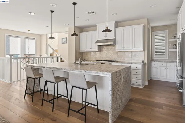 a kitchen with cabinets stainless steel appliances and cabinets