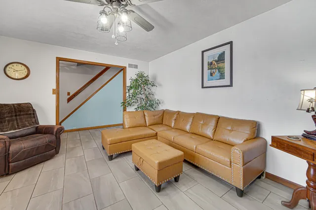 a dining hall with stainless steel appliances kitchen island granite countertop furniture and a fireplace