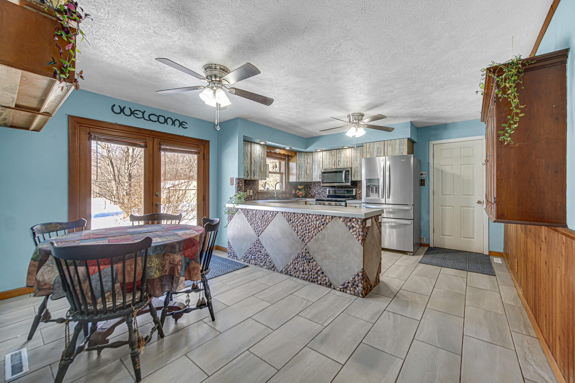 8524 North Wilhelm Road La Porte, IN 46350 - Photo 19 of 40 a dining hall with stainless steel appliances kitchen island granite countertop furniture and a fireplace