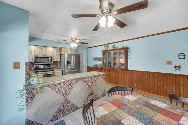 a kitchen with stainless steel appliances granite countertop a stove and a sink