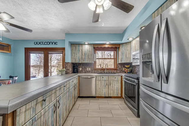 a bedroom with furniture and a large window