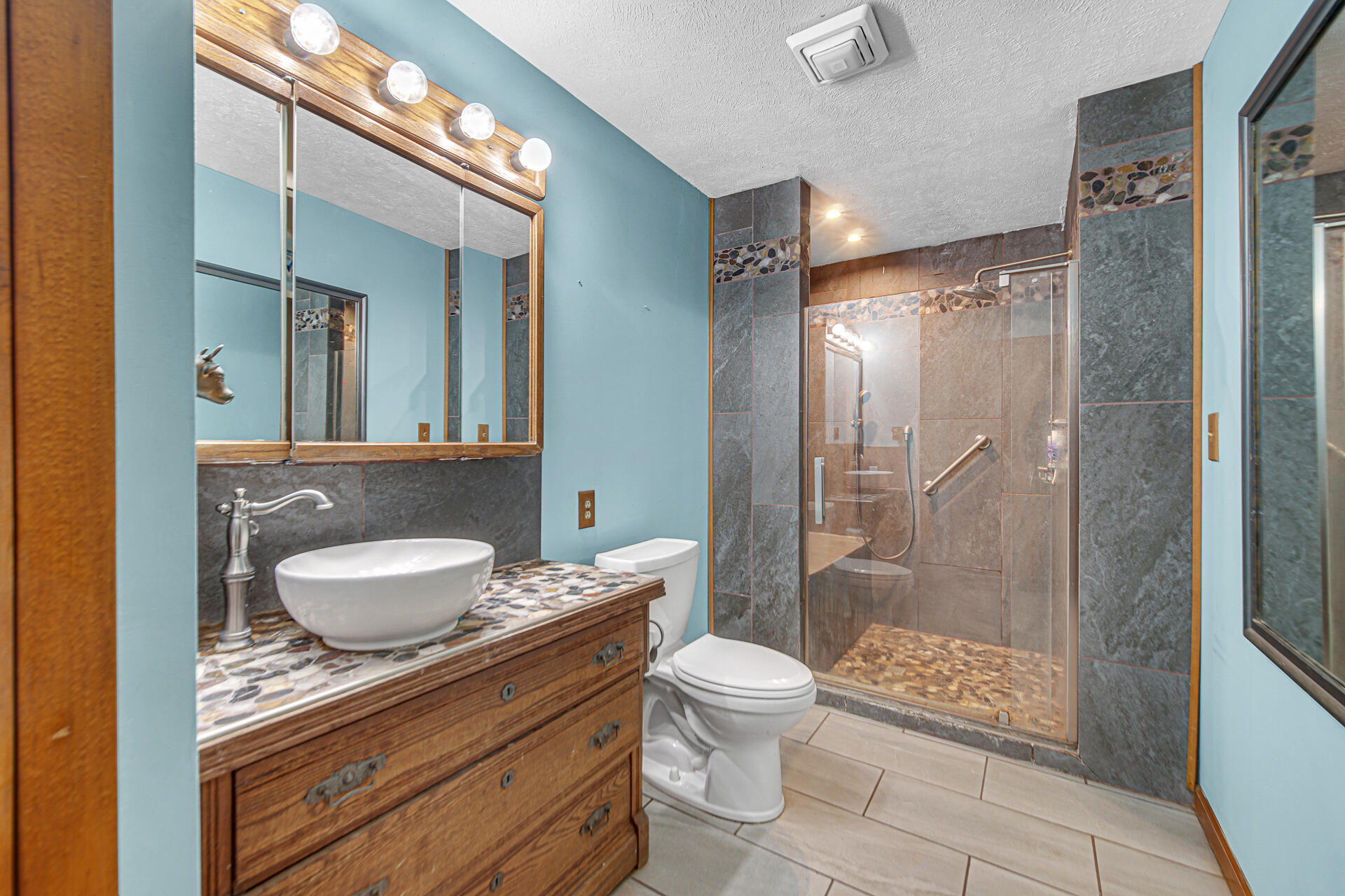 8524 North Wilhelm Road La Porte, IN 46350 - Photo 28 of 40 a bathroom with a granite countertop sink toilet a mirror and shower