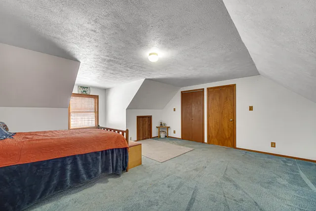 a room with a bed and a window