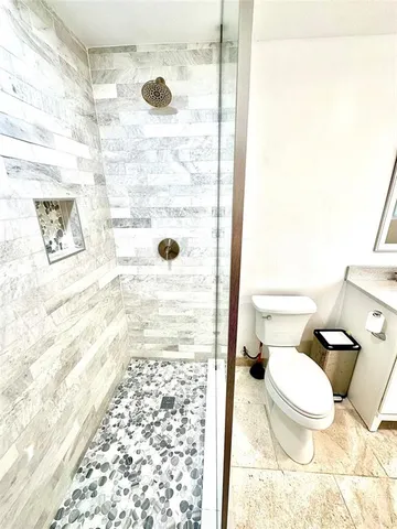 a bathroom with a toilet and a shower