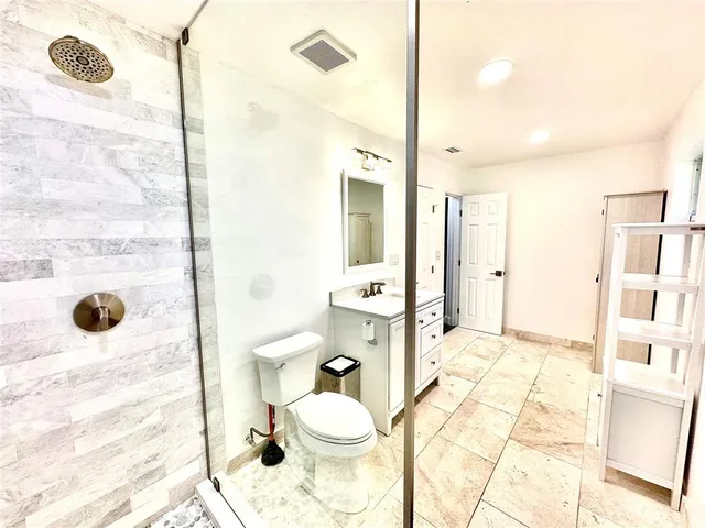 a bathroom with a sink toilet and shower