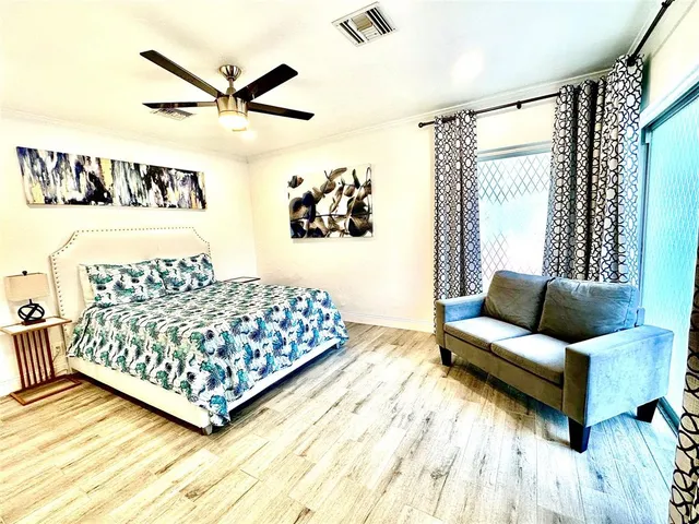 a living room with a bed furniture and a window