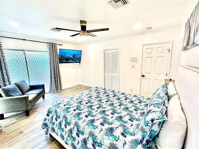 a bedroom with a bed and a chandelier