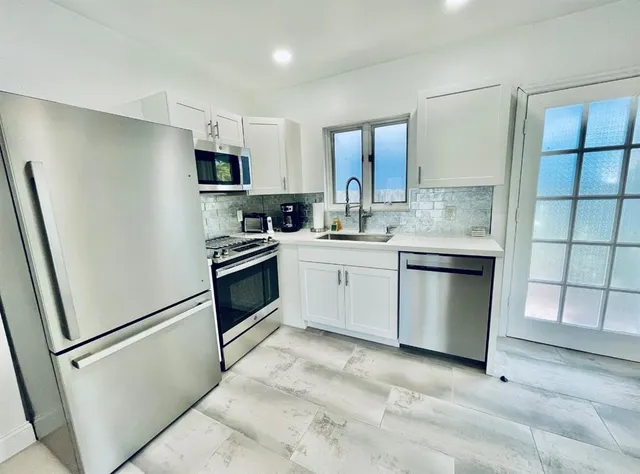 a kitchen with a sink stove and refrigerator