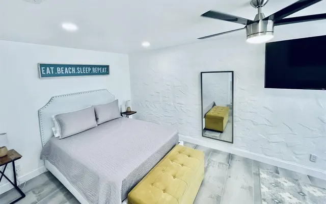 a bedroom with a bed and a television