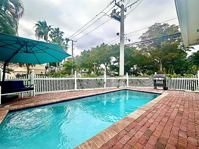 a view of a swimming pool with a patio and yard