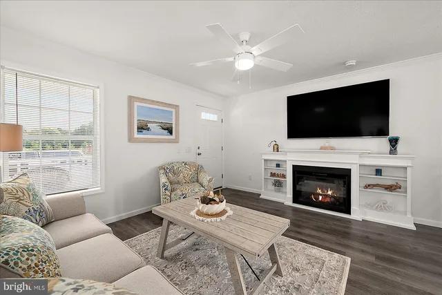 a kitchen with a refrigerator a microwave a stove and a sink with wooden floor