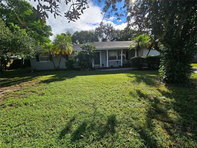 a view of house with backyard space and garden