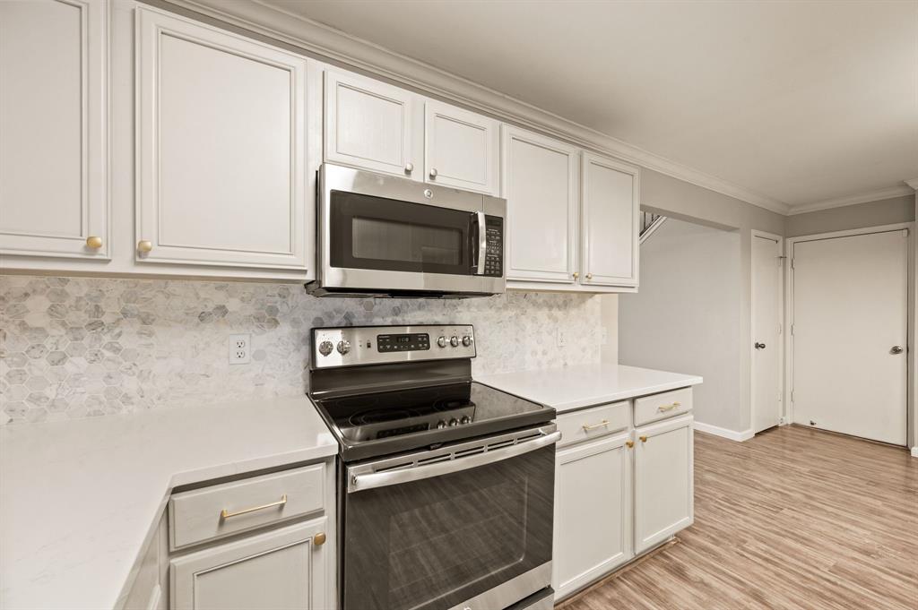 8713 Granite Path Fort Worth, TX 76244 - Photo 12 of 40 Stylish kitchen with updated cabinetry, sleek hardware, and stainless steel range and microwave.