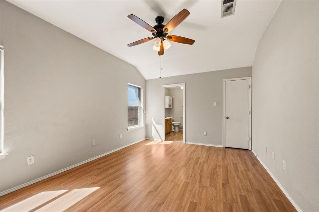 8713 Granite Path Fort Worth, TX 76244 - Photo 18 of 40 Spacious primary bedroom with vaulted ceiling, ceiling fan, and abundant natural light.