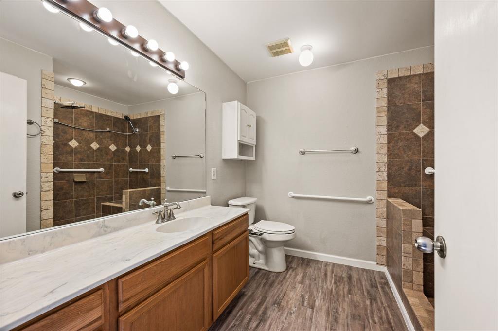 8713 Granite Path Fort Worth, TX 76244 - Photo 20 of 40 Full bathroom with extended vanity, large mirror, and walk-in tiled shower.