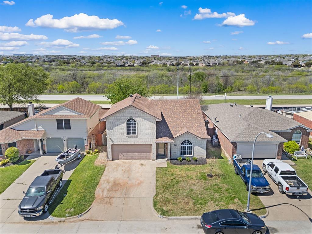 8713 Granite Path Fort Worth, TX 76244 - Photo 2 of 40 Aerial view showcasing the home’s position on a quiet street with easy access to nearby roadways and greenbelt.