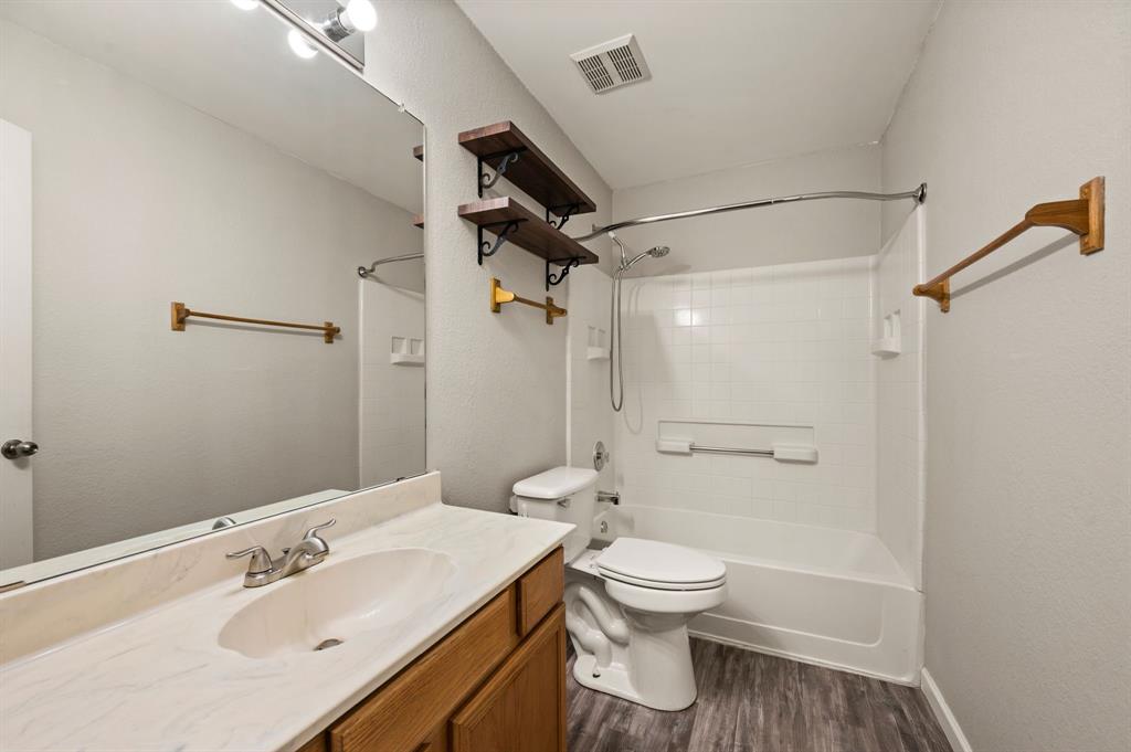 8713 Granite Path Fort Worth, TX 76244 - Photo 22 of 40 Full bathroom with extended vanity, large mirror, updated fixtures, and tub-shower combo.