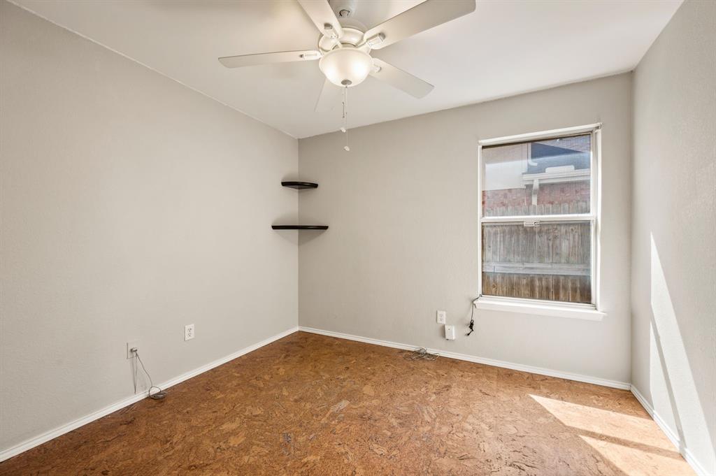 8713 Granite Path Fort Worth, TX 76244 - Photo 23 of 40 Additional bedroom featuring cork-style flooring, ceiling fan, and corner shelving accents.