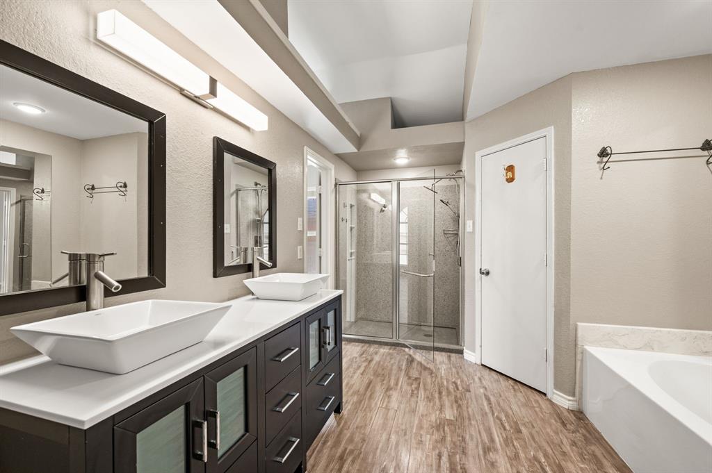 8713 Granite Path Fort Worth, TX 76244 - Photo 33 of 40 Ensuite bath with soaking tub, dual vanities, and walk-in shower with glass enclosure.
