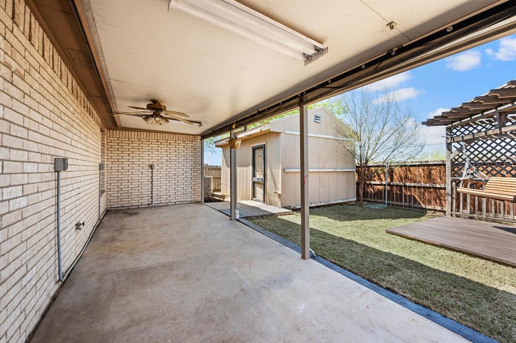 8713 Granite Path Fort Worth, TX 76244 - Photo 34 of 40 Covered back patio with ceiling fan and ample space for outdoor seating.