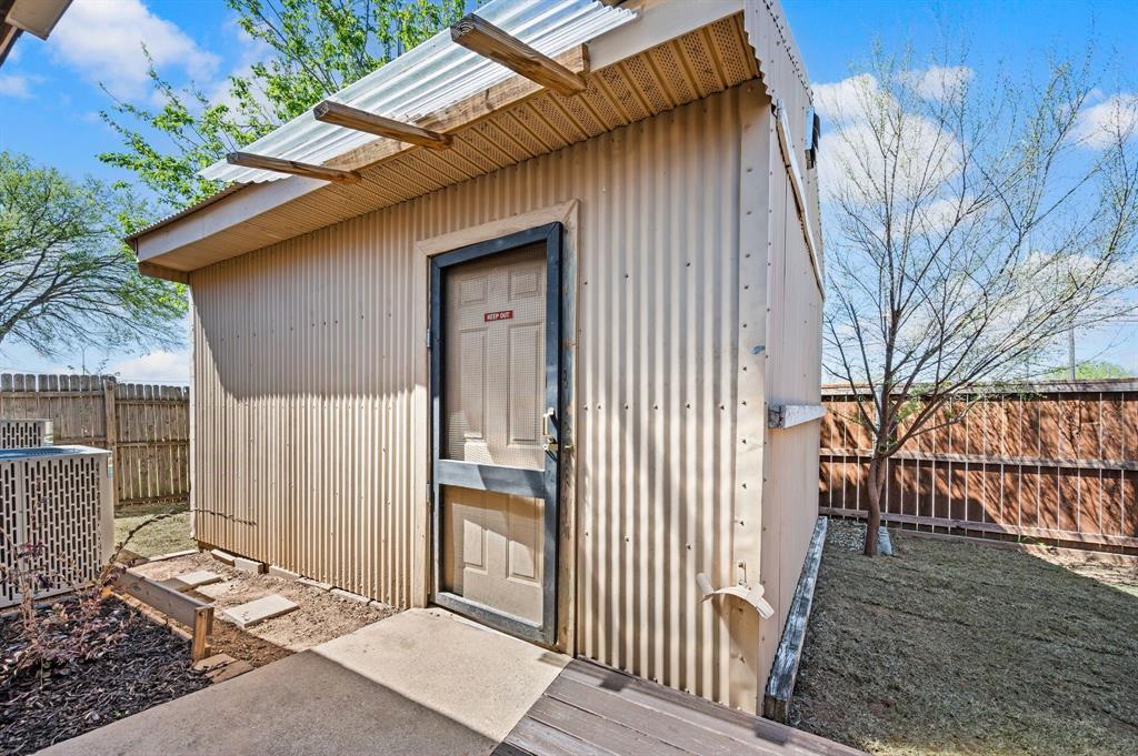 8713 Granite Path Fort Worth, TX 76244 - Photo 36 of 40 Backyard storage building with corrugated metal exterior and private access.