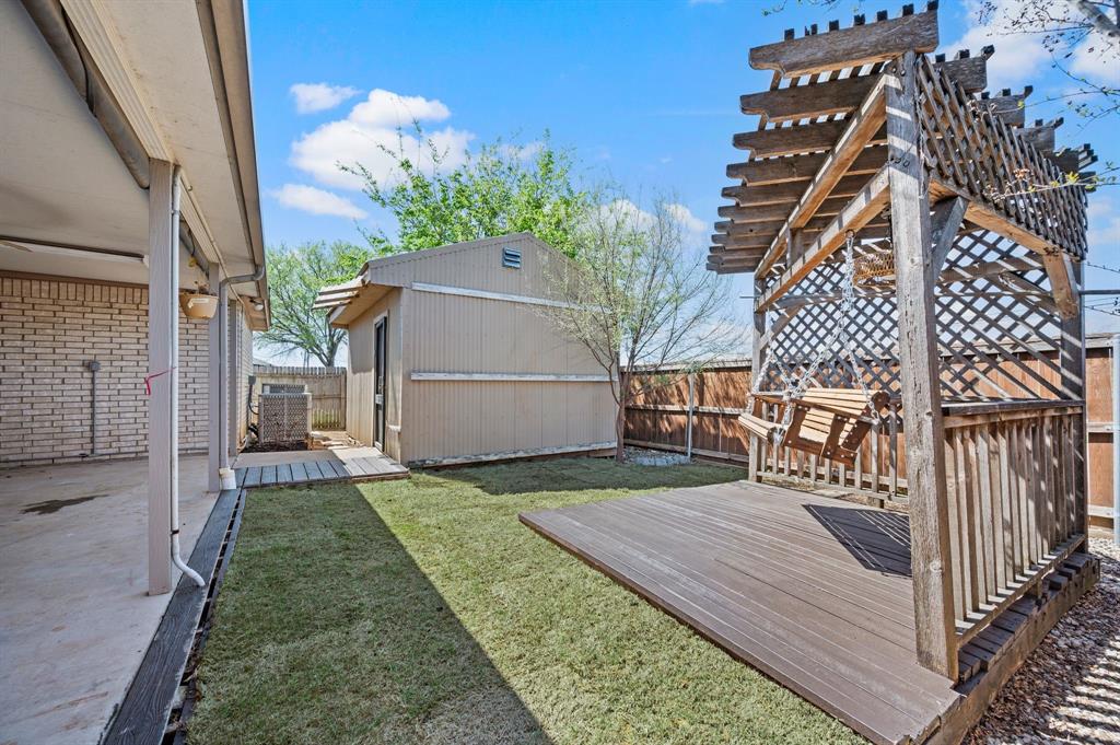 8713 Granite Path Fort Worth, TX 76244 - Photo 38 of 40 Alternate view of backyard showcasing pergola, lawn space, and storage building.