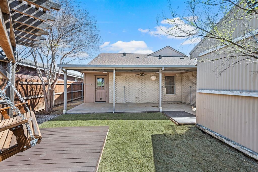 8713 Granite Path Fort Worth, TX 76244 - Photo 39 of 40 Rear elevation featuring covered patio, fenced yard, and outdoor living areas.