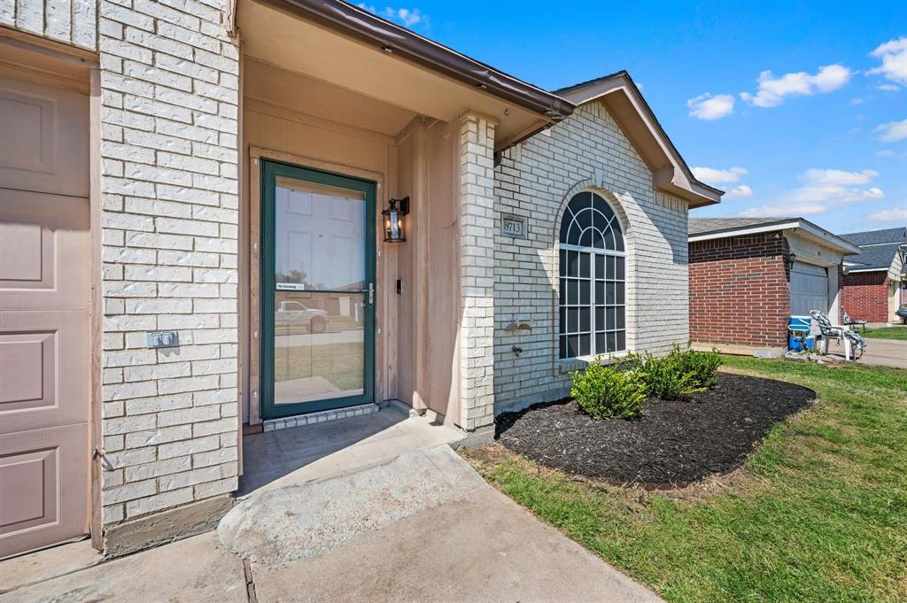 8713 Granite Path Fort Worth, TX 76244 - Photo 4 of 40 Welcoming front entry with covered porch, updated landscaping, and decorative lighting.