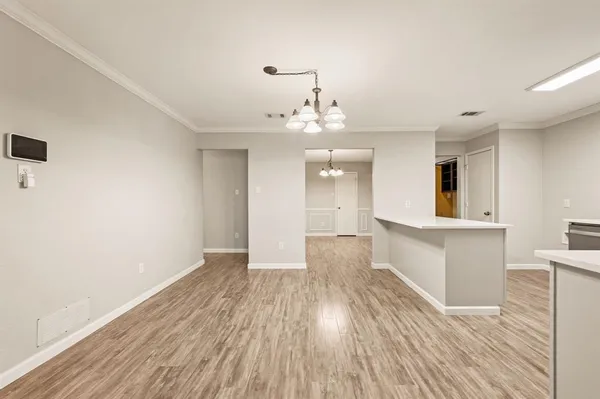 a view of a room with wooden floor and staircase