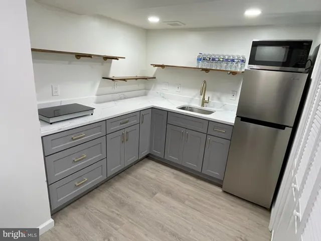 a kitchen with stainless steel appliances granite countertop a refrigerator sink and cabinets