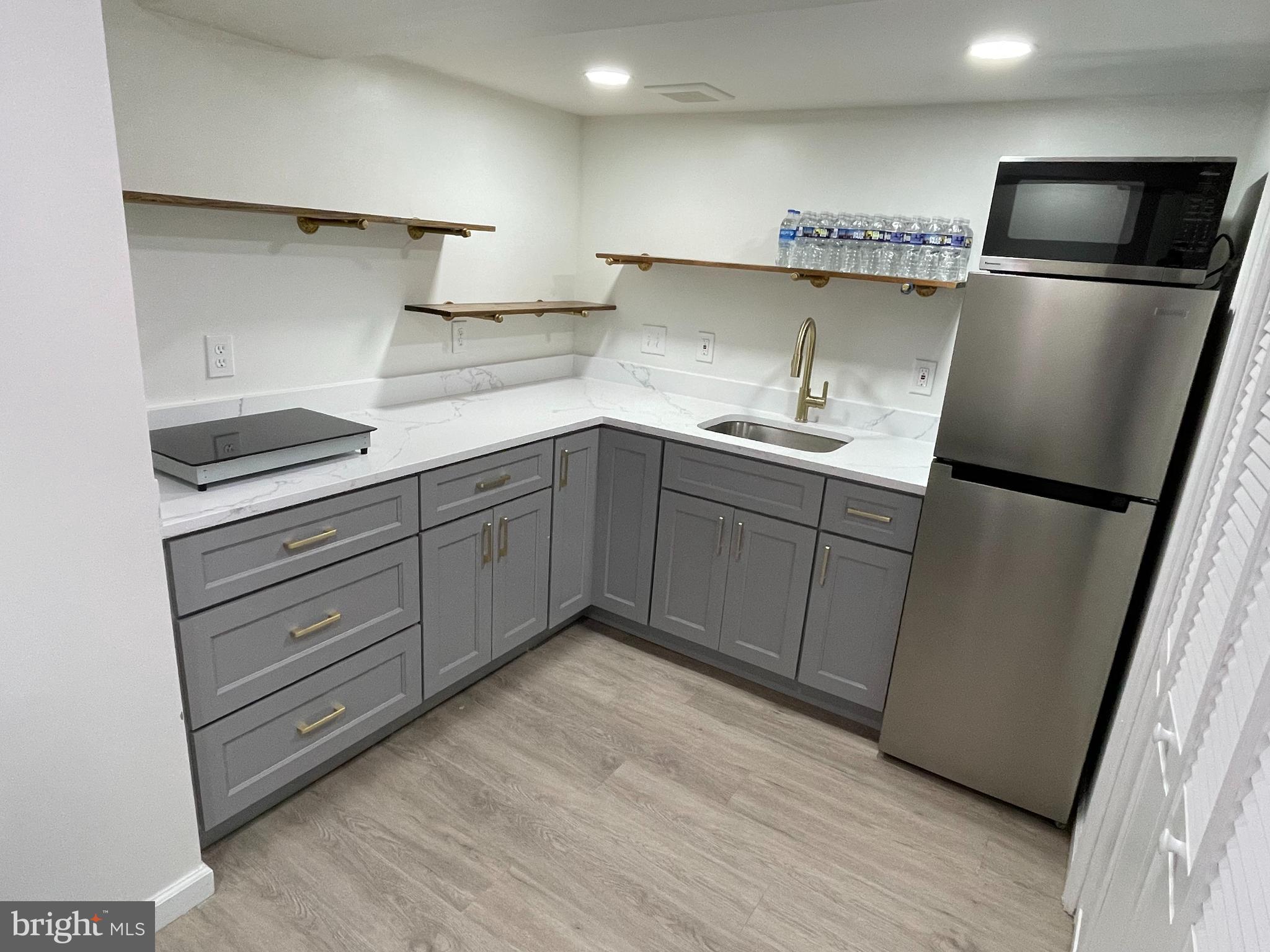 a kitchen with stainless steel appliances granite countertop a refrigerator sink and cabinets