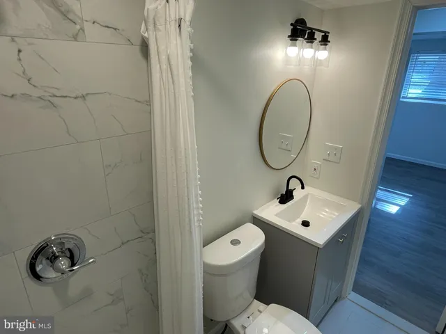a bathroom with a toilet sink and mirror